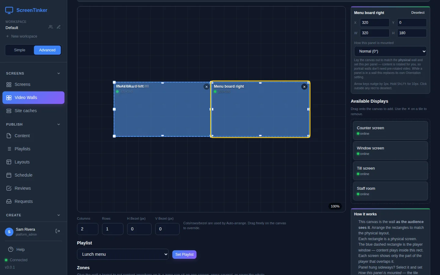 The wall canvas with two screen rectangles side by side under the player window. Menu board right is selected, and the panel on the right shows X 320, Y 0, W 320, H 180 and How this panel is mounted set to Normal (0°). Below the canvas: Columns 2, Rows 1, H Bezel 0, V Bezel 0, and the Playlist picker set to Lunch menu with a Set Playlist button. On the right, Available Displays lists the other screens.